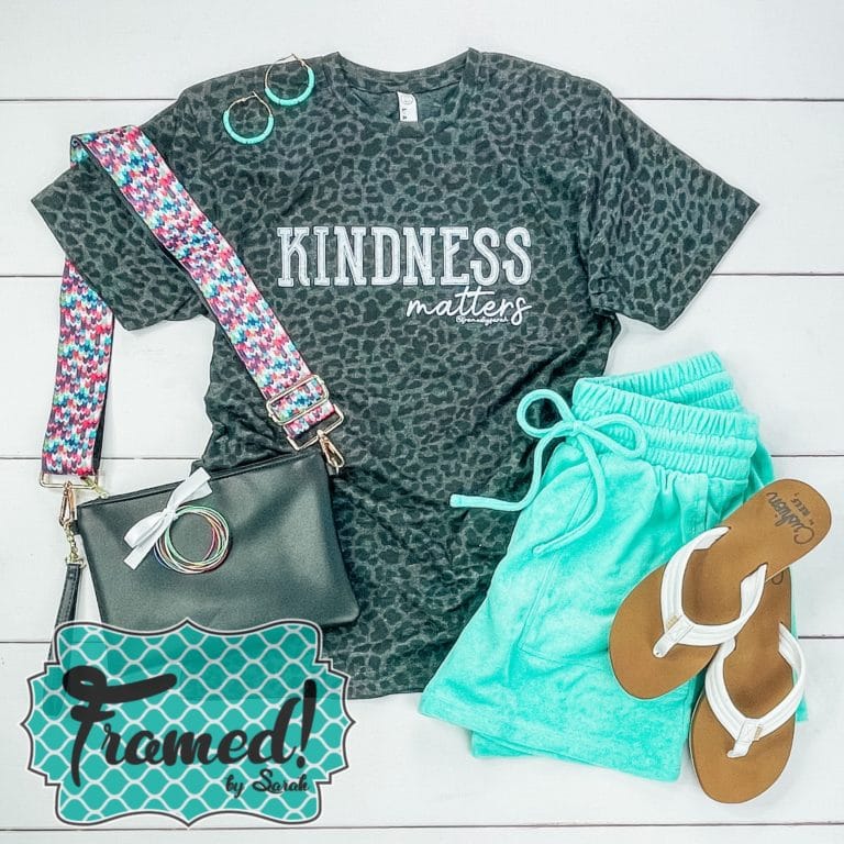 Leopard print Kindness Matters T-shirt Club Tee styled with turquoise shorts and a guitar strap handbag