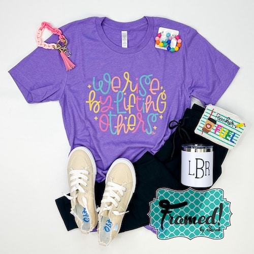 purple "We Rise by Lifting Others Graphic Tee" styled with black joggers, ivory sneakers, coral chain keychain bracelet, monogrammed white tumbler, "teacher fuel" beaded zipper pouch, colorful ball hoop earrings