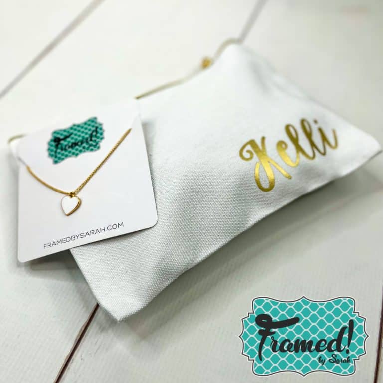 white enamel heart and white personalized pouch with gold accents