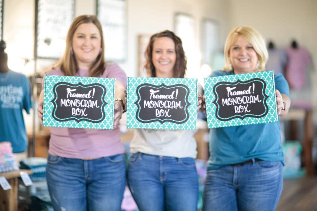 3 women holding out Framed! Monogram Boxes