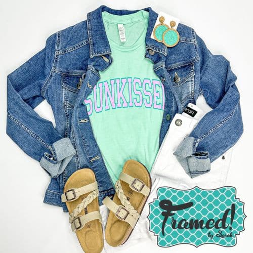 Mint Sunkissed t-shirt styled with denim jacket, white jeans, and nature sandals