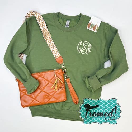 Olive green monogrammed sweatshirt with tan crossbody bag and wooded earrings