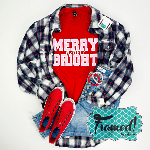 Red Merry and Bright tee styled with plaid shirt, red shoes, and jeans