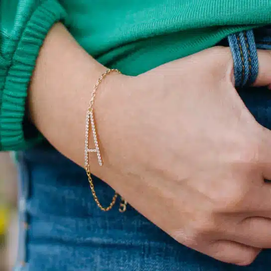 Gold Initial Bracelet on a womans wrist