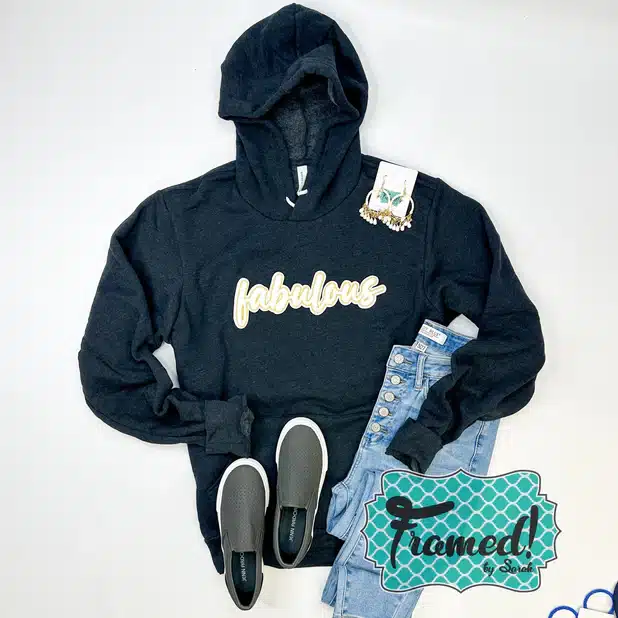 Black 'Fabulous' Ultra Soft Hoodie styled with gray sneakers, jeans, and ivory beaded earrings
