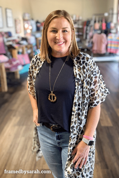 woman wearing leopard kimono styled with black t-shirt and long pendant necklace